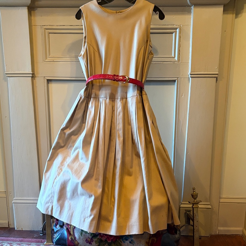 100% Cotton sleeveless dress with full skirt and red/gold snakeskin belt.